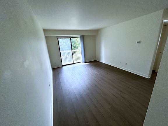 A living room with vinyl plank floors and white walls.