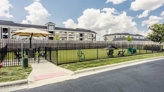 A sunny day at a residential area with apartment buildings and a playground.