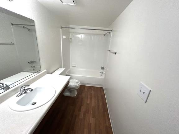 A white sink and toilet in a small bathroom.