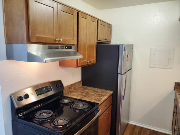 a kitchen with a stove and a refrigerator at Huntington Place Apartments, Michigan, 48732
