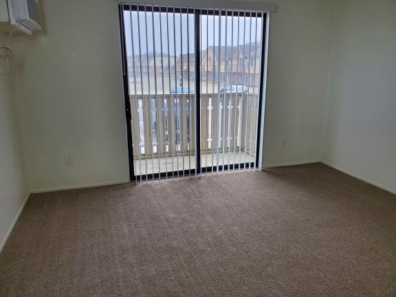 an empty living room with a sliding glass doorat Woodland Place, Michigan