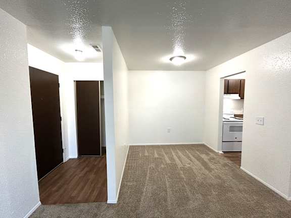 A dining room with a carpeted floor and a white ceiling.