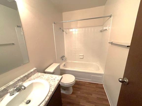 A white sink with a white countertop in a small bathroom.