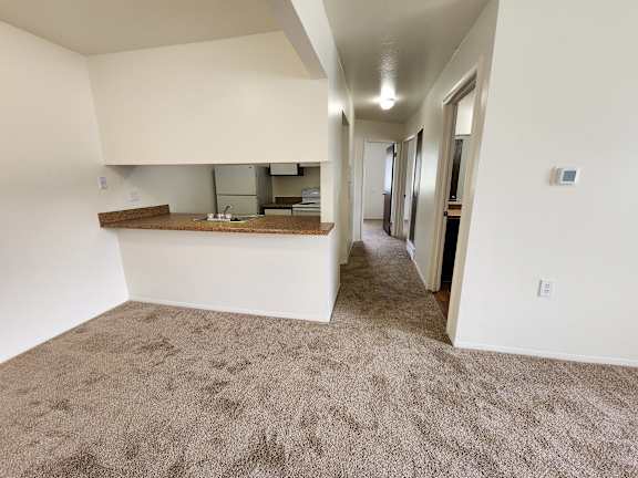 The dining room on the left with ta breakfast bar and kitchen.