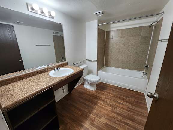 A bathroom with a toilet, sink, and bathtub.