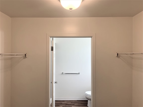a small bathroom with a toilet and a white door