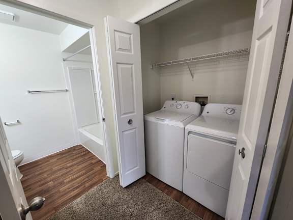 Full-sized washer and dryer located in apartment.