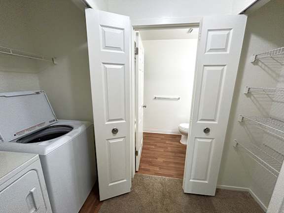 A laundry  closet with a washer and dryer.