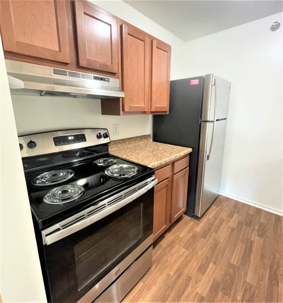 an empty kitchen with a stove and a refrigeratorat Woodland Place, Michigan, 48640