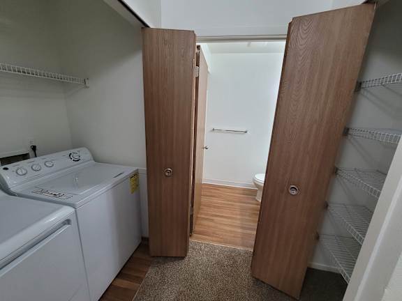 A laundry closet with a washer and dryer.