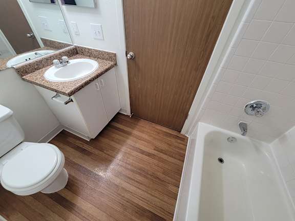 A white toilet sits next to a sink in a small bathroom.
