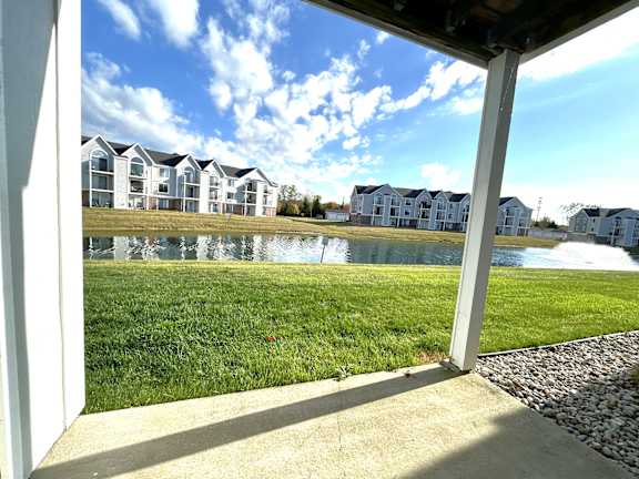Covered patio with pond and fountain view at Heatherwood Apartments, Grand Blanc, MI 48439