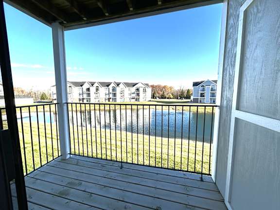 Covered porch with pond and community views at Heatherwood Apartments, Grand Blanc
