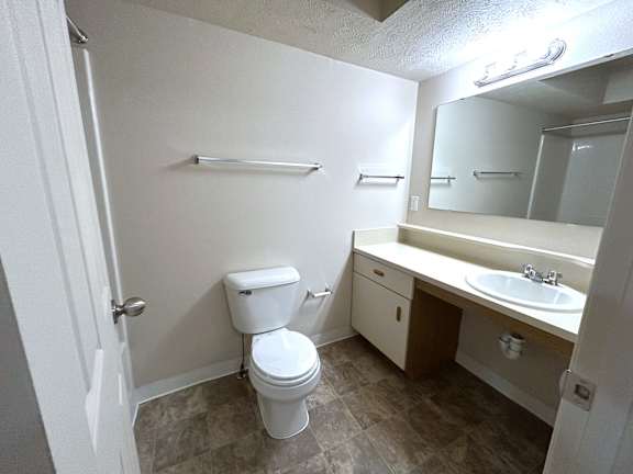 Bathroom with white vanity sink and toilet at Heatherwood Apartments, Michigan, 48439