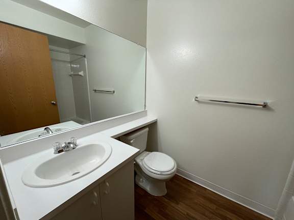 A white sink and toilet in a small bathroom.