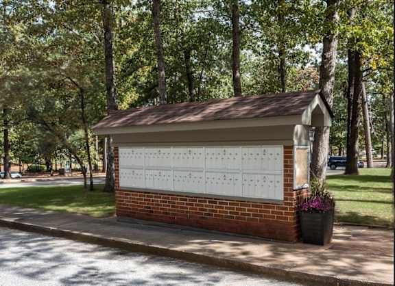 A small building with a calendar on the wall and a tree in front of it at Laurel Woods Apartments, South Carolina, 29607