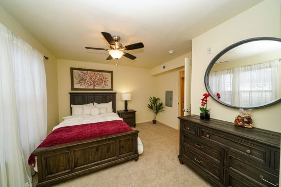 a bedroom with a bed and a ceiling fan  at Andover Pointe Apartment Homes, La Vista, NE, 68138