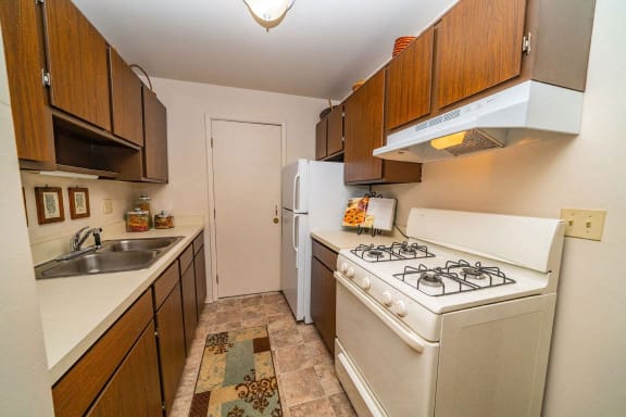a kitchen with a stove and a refrigerator at Apple Ridge Apartments, Walker, MI, 49534