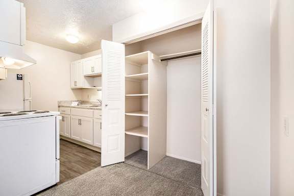 A white kitchen and a large closet at Apple Ridge Apartments, Michigan, 49534