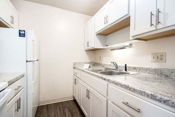 An upgraded kitchen with white, shaker-style cabinets at Apple Ridge Apartments, Michigan, 49534