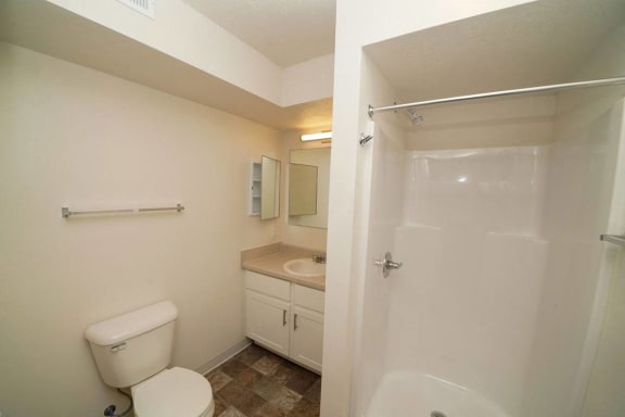 a bathroom with a toilet and a sink and a shower  at Arbor Lakes Apartments, Indiana, 46516