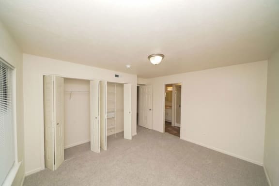 an empty living room with a closet