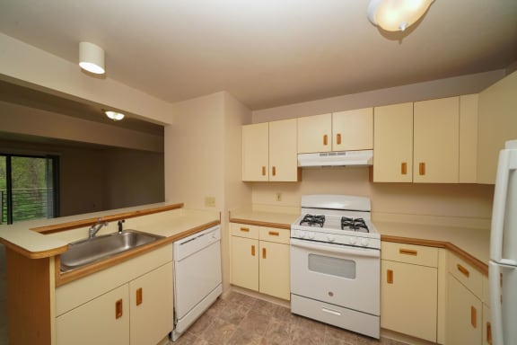 a kitchen with white appliances and white cabinets at Autumn Lakes Apartments and Townhomes, Mishawaka, IN, 46544