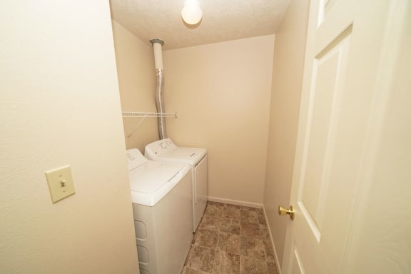 a small bathroom with a washer and dryer in it at Autumn Lakes Apartments and Townhomes, Mishawaka, IN