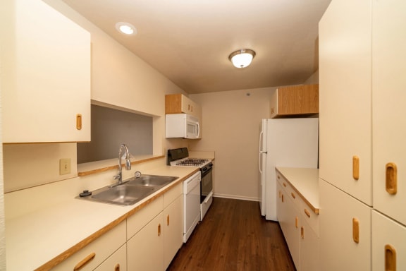 a kitchen with a sink and a stove and a refrigerator at Autumn Lakes Apartments and Townhomes, Mishawaka, IN