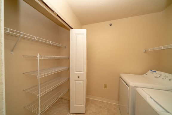 a laundry room with a washer and dryer and a closet at Autumn Lakes Apartments and Townhomes, Mishawaka