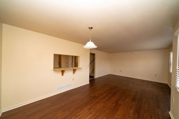 an empty living room with a hard wood floor at Autumn Lakes Apartments and Townhomes, Indiana