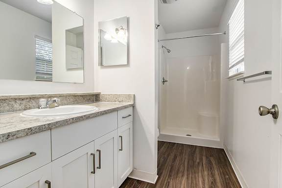 A bathroom with a sink, mirror, and window at Autumn Lakes Apartments and Townhomes, Mishawaka, 465444