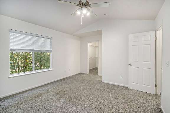 A bedroom with a ceiling fan and carpeted floor at Autumn Lakes Apartments and Townhomes, Mishawaka, 46544