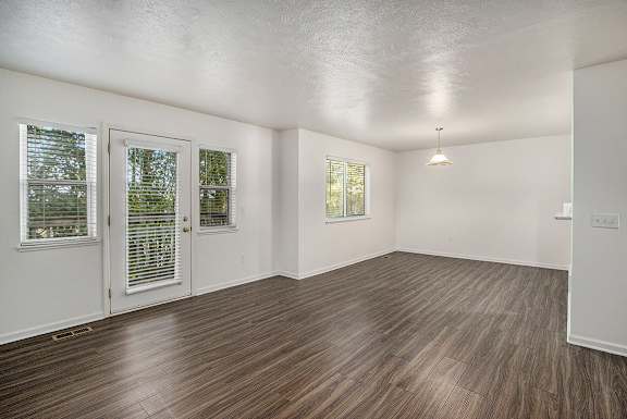 A living and dining room with vinyl plank flooring at Autumn Lakes Apartments and Townhomes, Mishawaka, 46544
