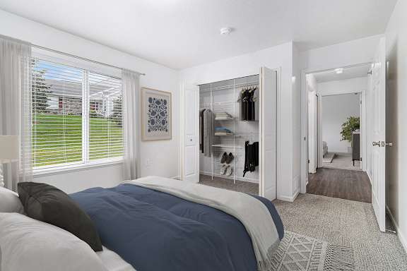 A bedroom with a carpeted floor and a window with blinds at Autumn Lakes Apartments and Townhomes, Mishawaka, 46544