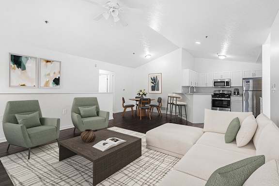 A large living room with vinyl plank flooring and a kitchen area in the background at Autumn Lakes Apartments and Townhomes, Mishawaka, 46544
