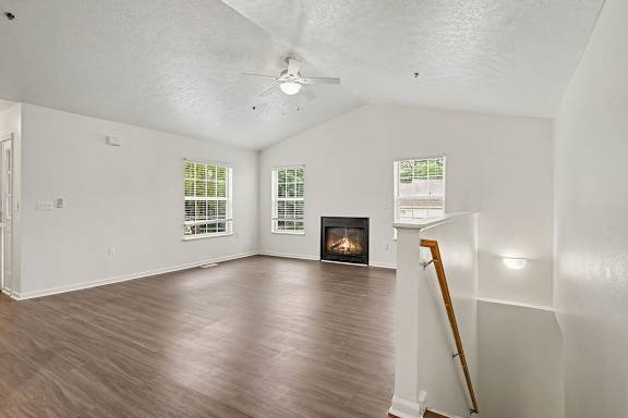 A room with a fireplace and a wooden floor.