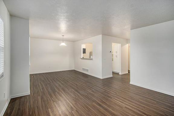 A room with wooden flooring and white walls
