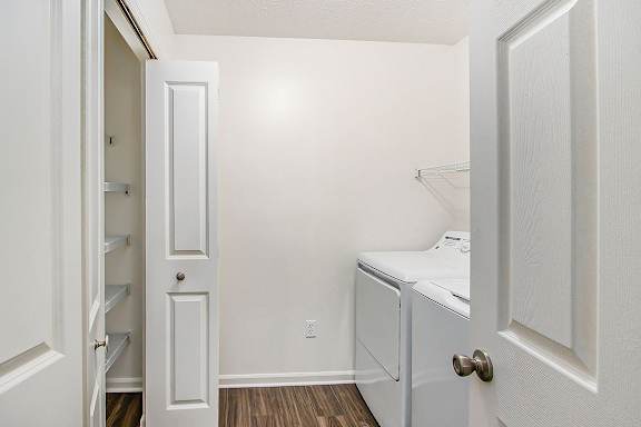 A small white laundry room with a washer and dryer