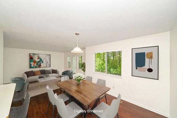 A dining room with a wooden table and chairs A dining room with a wooden table and chairs at Autumn Lakes Apartments and Townhomes in Mishawaka, Indiana