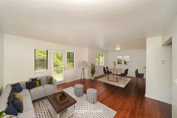 A living room with a grey couch, a coffee table, and a rug A living room with a grey couch, a coffee table, and a rug at Autumn Lakes Apartments and Townhomes, Indiana