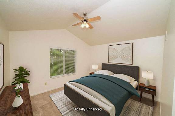 A bedroom with a bed, a ceiling fan, and a cathedral ceiling A bedroom with a bed, a ceiling fan, and a cathedral ceiling at Autumn Lakes Apartments and Townhomes, Indiana, 46544