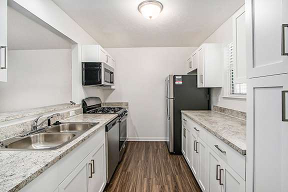 A kitchen with white, shaker-style  cabinets and stainless steel appliances at Autumn Lakes Apartments and Townhomes, Mishawaka, 46544