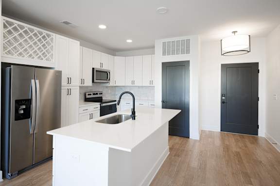 a large white kitchen with stainless steel appliances and a white counter top at Avant & Avant II, Carmel, IN, 46032