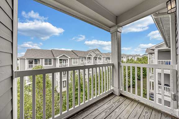 the view from the deck of a home with a balcony at Avellan Springs Apartments, Morrisville, North Carolina