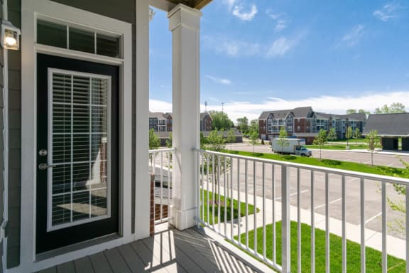 a balcony with a door and a street in the background at 24 at Bloomfield, Bloomfield Township, Michigan