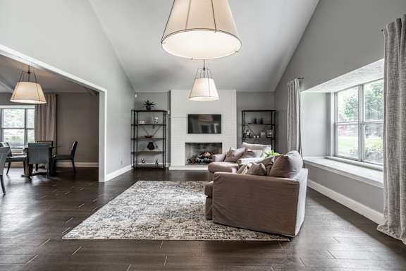 A living room with a fireplace and a couch at Bay Pointe Apartments, Lafayette, IN