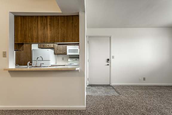 A kitchen with white appliances and a white door at Bay Pointe Apartments, Lafayette, IN