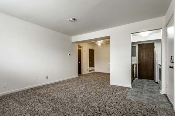 A spacious room with a carpeted floor and white walls at Bay Pointe Apartments, Lafayette, IN, 47909
