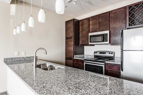 a kitchen with a granite counter top and a sink at Bella Vista Apartments, Fishers, IN, 46038